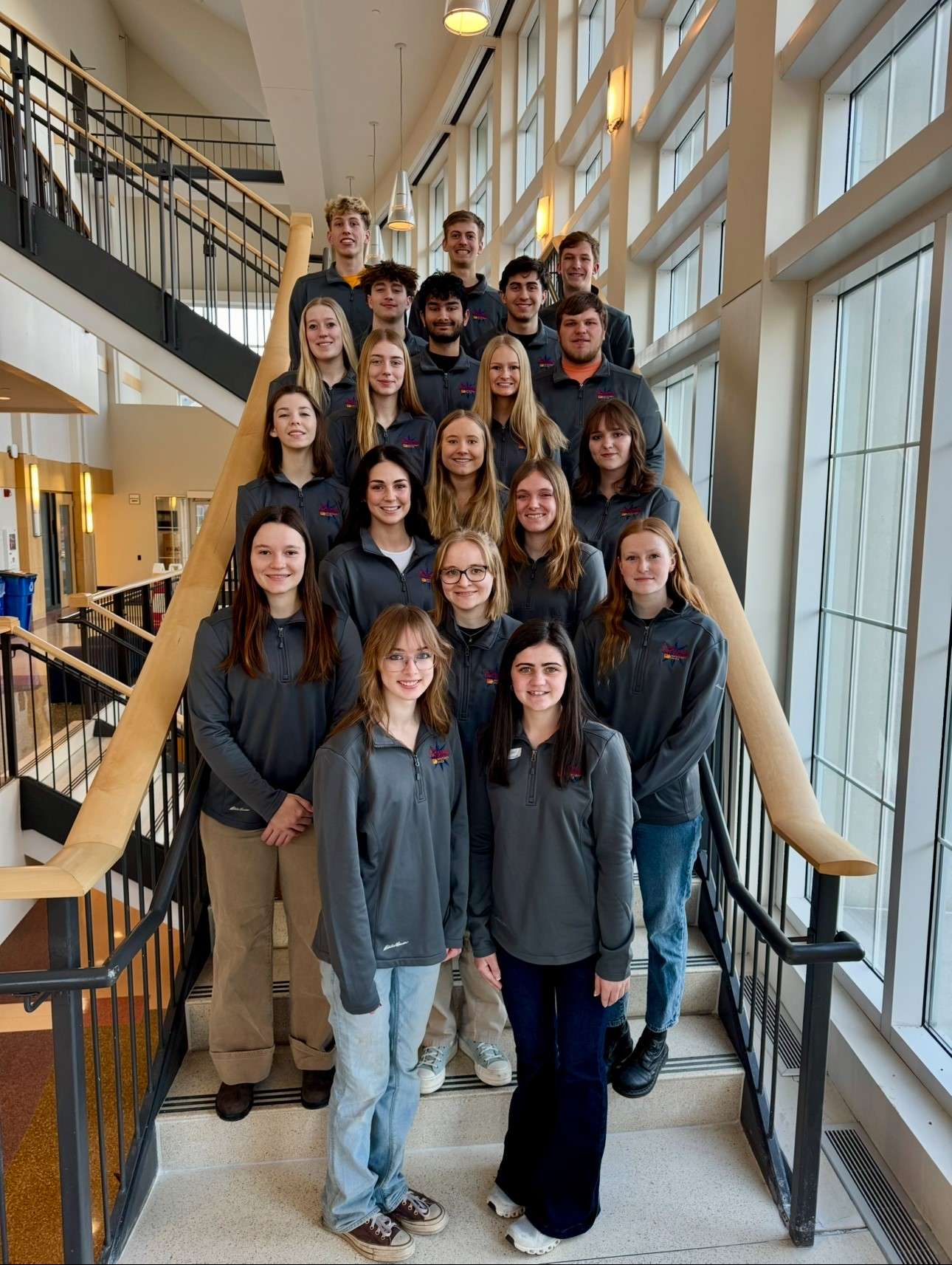 Photo of Hixson Peer Mentors for 2025 arranged in rows on the steps in Hixson-Lied Student Success Center at Iowa State University